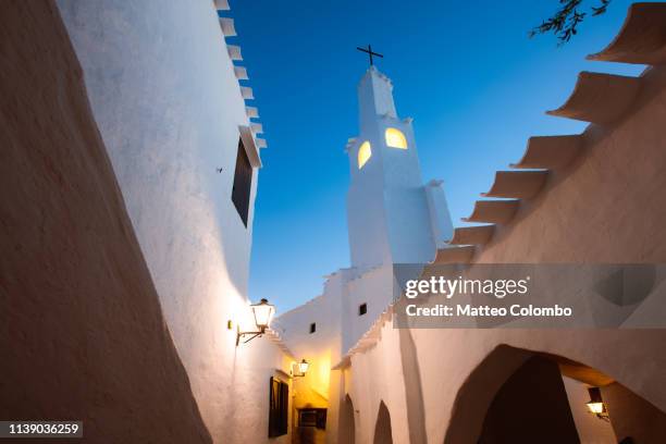 bell tower at dusk, binibeca vell, menorca - minorca stock-fotos und bilder