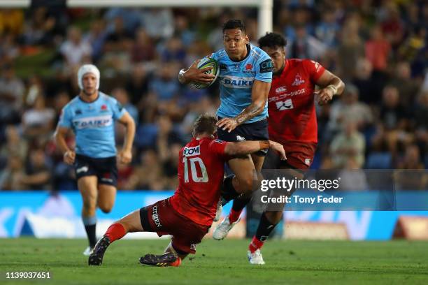 Israel Folau of the Waratahs is tackled during the round seven Super Rugby match between the Waratahs and the Sunwolves at McDonald Jones Stadium on...