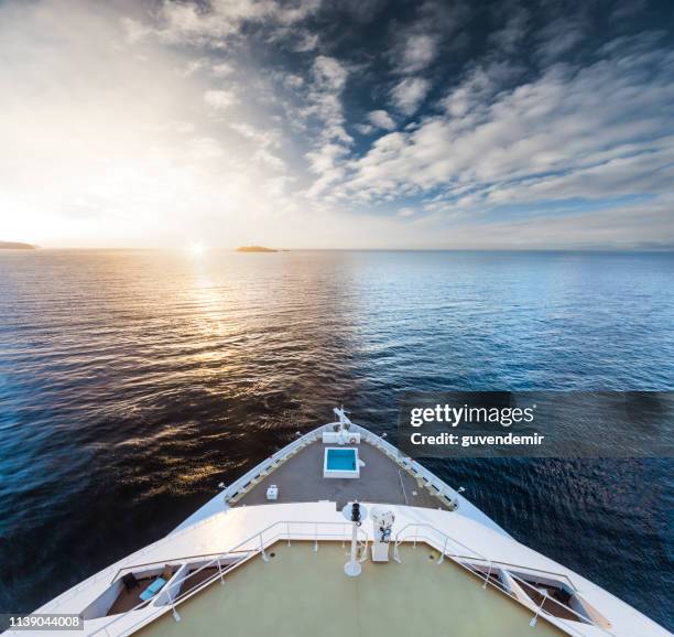 watching the sunrise at cruise ship bow - cruise liner stock pictures, royalty-free photos & images