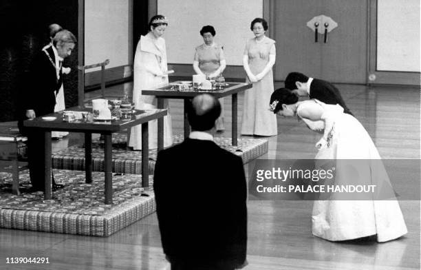 The newlywed Crown Prince Naruhito and his wife, Crown Princess Masako , bow before Emperor Akihito and Empress Michiko at the Imperial Palace to...