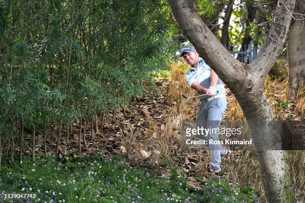Stephen Gallacher of Scotland plays his third shot on the 4th hole during round two of the Hero Indian Open at the DLF Golf & Country Club on March...