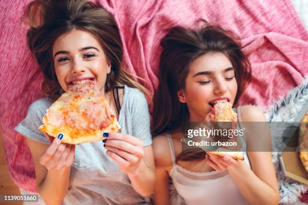 female slumber party - pizza party stock pictures, royalty-free photos & images