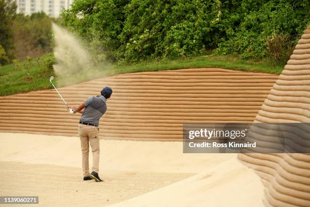 Syed Saqib Ahmed of India plays his second shot on the 4th hole during round two of the Hero Indian Open at the DLF Golf & Country Club on March 29,...