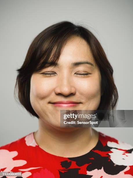 portrait of real chinese mature woman with happy expression and eyes closed - woman portrait eyes closed stock pictures, royalty-free photos & images