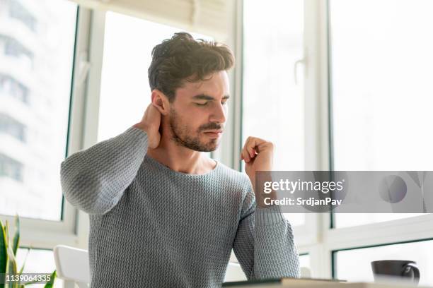 dealing with pain - human neck stock pictures, royalty-free photos & images