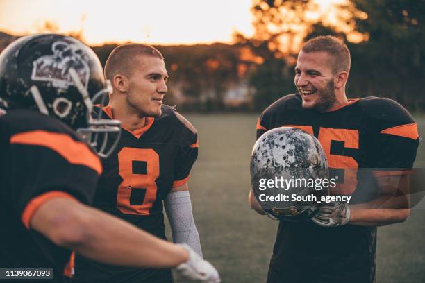 pep talk - american football uniform stock pictures, royalty-free photos & images