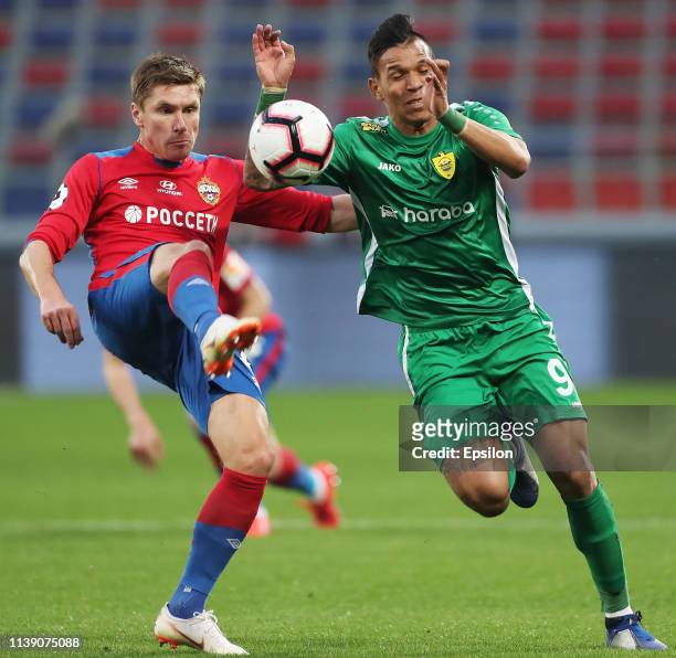 Kirill Nababkin of PFC CSKA Moscow and Andres Ponce of FC Anji Makhachkala vie for the ball during the Russian Football League match between PFC CSKA...