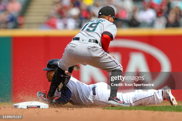 Cleveland Indians third baseman Jose Ramirez stems second base as the throw gets away from Miami Marlins infielder Miguel Rojas during the fourth...