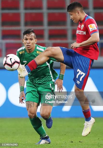 Ilzat Akhmetov of PFC CSKA Moscow and Andres Ponce of FC Anji Makhachkala vie for the ball during the Russian Football League match between PFC CSKA...