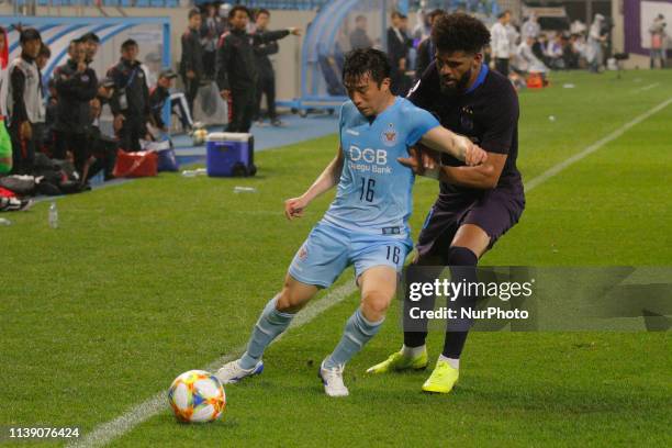 April 23, 2019-Daegu, South Korea-Anderson Patric Oliviera of Sanfrecce Hiroshima and Kang Yun Woo of Daegu FC action on the ground during an AFC...