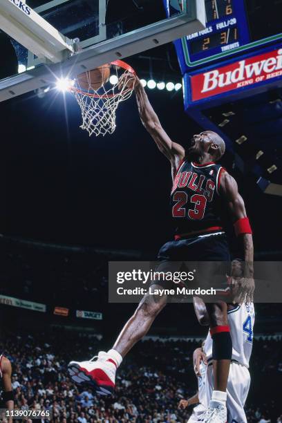 Michael Jordan of the Chicago Bulls dunks the ball against the Dallas Mavericks on March 12, 1998 at the Reunion Arena in Dallas, Texas. NOTE TO...