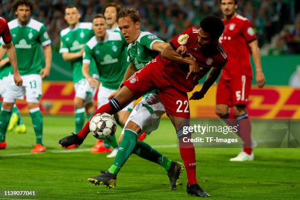 Ludwig Augustinsson of SV Werder Bremen and Serge Gnabry of FC Bayern Muenchen battle for the ball during the DFB Cup semi final match between Werder...
