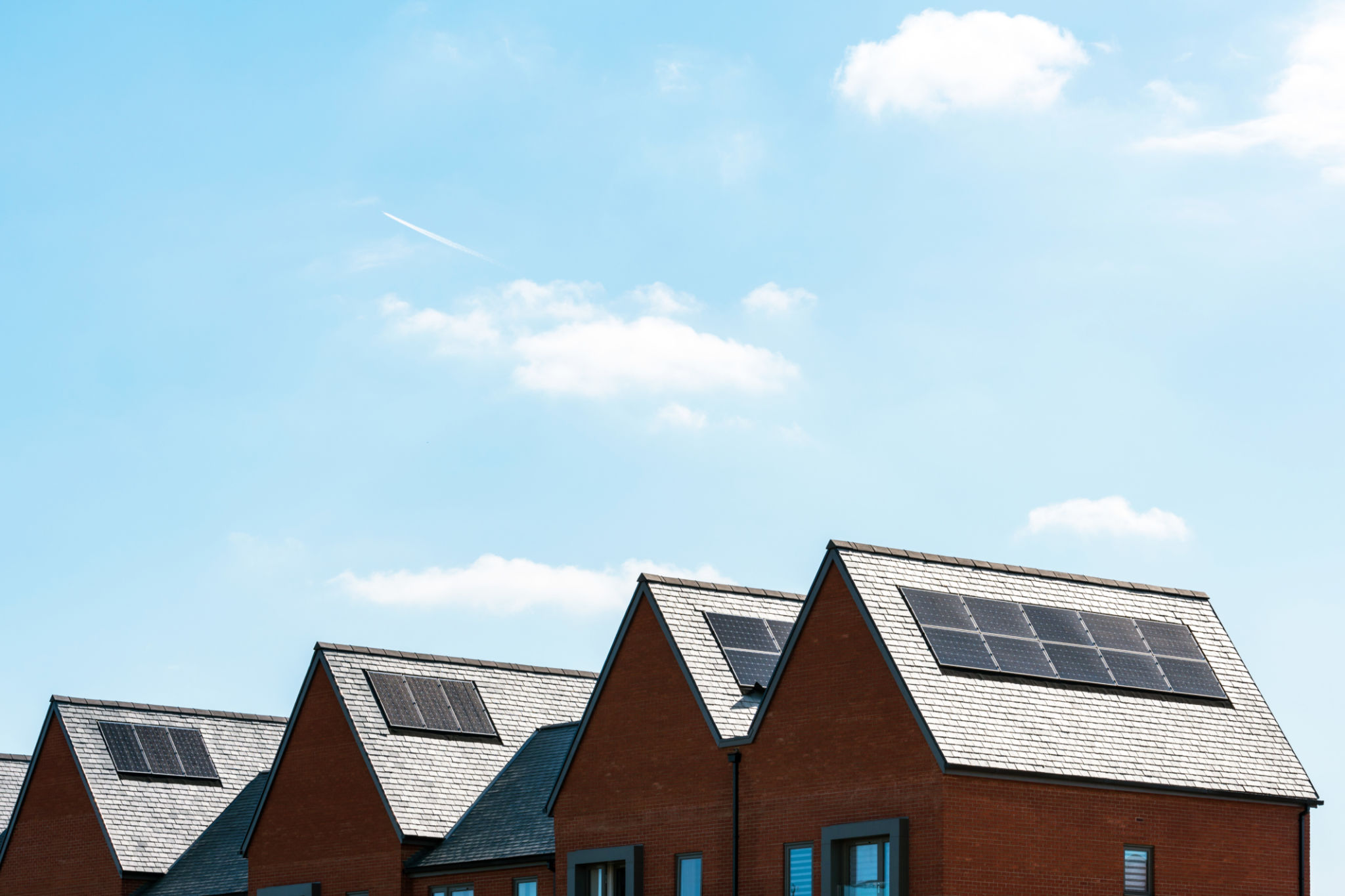 solar panels on roof of new houses in england uk on bright sunny day solar panels on roof of new houses in england uk on bright sunny day