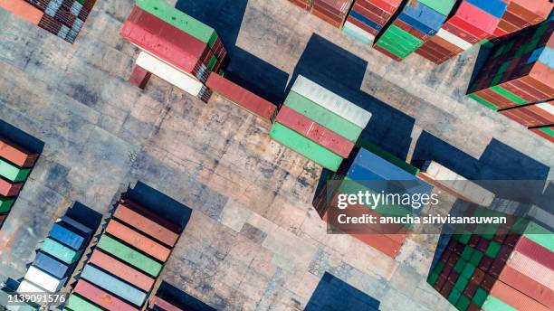 aerial top view crane truck drive lifting container in warehouse. - box lifting technique stock-fotos und bilder