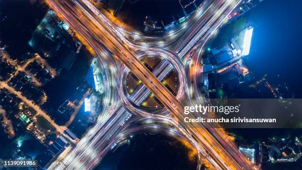 aerial view, expressway road intersection, traffic in bangkok at night, thailand. - bangkok aerial stock pictures, royalty-free photos & images