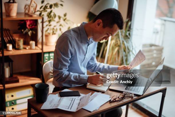 man calculating his financial bills - bank statement stock pictures, royalty-free photos & images