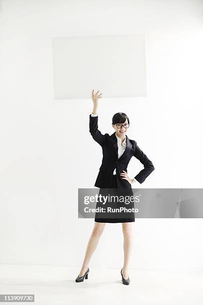 young business woman with a panel - women only holding placards stock-fotos und bilder