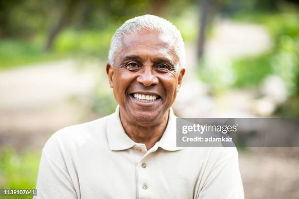 smiling senior black man outdoors - filipino woman smiling stock pictures, royalty-free photos & images