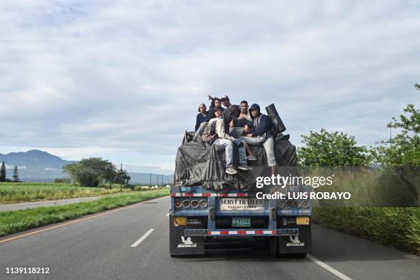 Venezuelan migrants take a ride on the back of a truck along the Pan-American Highway in Santander de Quilichao, department of Cauca, Colombia, on...