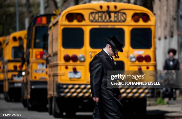 Jewish man crosses a street in a Jewish quarter in Williamsburg Brooklyn in New York City on April 24, 2019. A New York county hit by a measles...