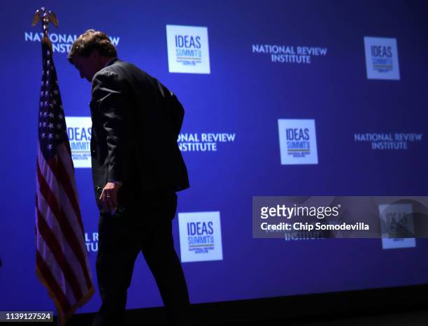 Fox News host Tucker Carlson leaves the stage after talking about 'Populism and the Right' during the National Review Institute's Ideas Summit at the...