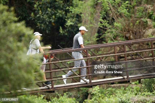 Tiger Woods of the United States crosses the bridge on the fourth hole in his match against Patrick Cantlay of the United States during the third...
