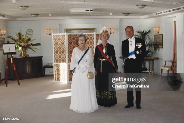 Queen Elizabeth II, President of Iceland, Vigdis Finnbogadottir, and Prince Philip on board the royal yacht Britannia during a three-day State Visit...