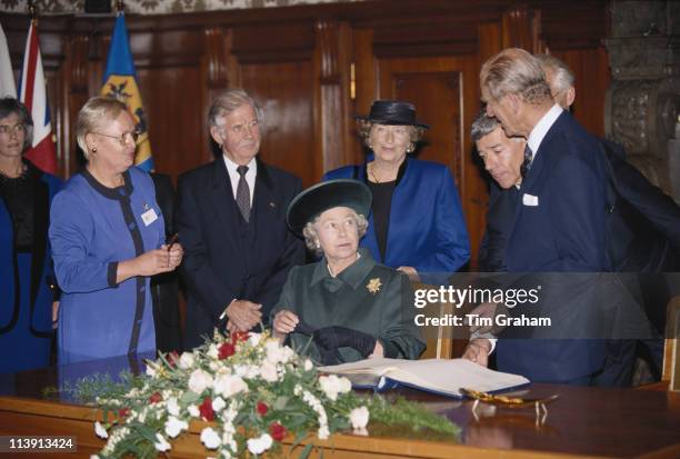 Queen Elizabeth II looking up at Prince Philip after signing the guest book at the Kreuzkirche in Dresden, Germany, 22 October 1992.