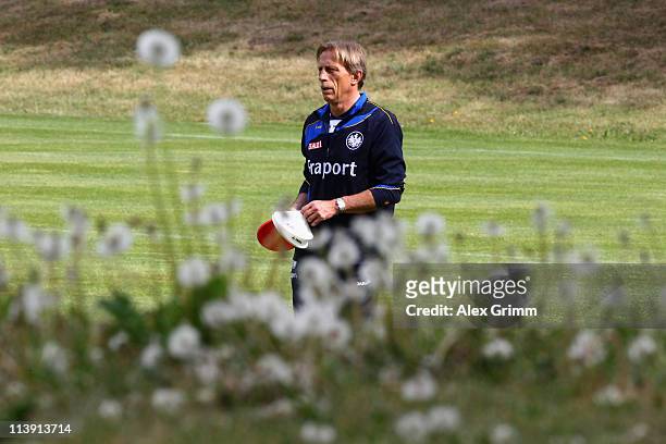 Head coach Christoph Daum walks over the pitch during a training session of Eintracht Frankfurt at Commerzbank Arena on May 10, 2011 in Frankfurt am...