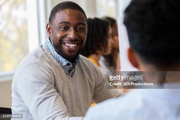 african american male is excited about job opportunities - job fair stock pictures, royalty-free photos & images