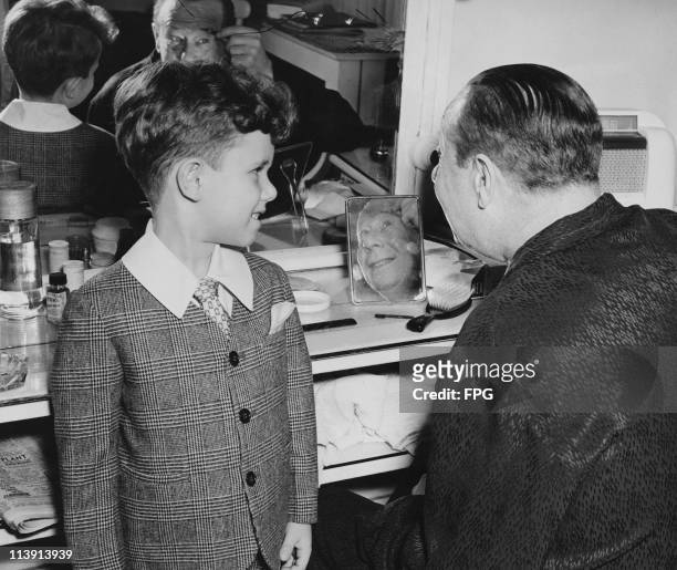 American actor and comedian Bert Lahr in his dressing room backstage at the Belaco Theater with his son John, circa 1947. Lahr senior is appearing in...