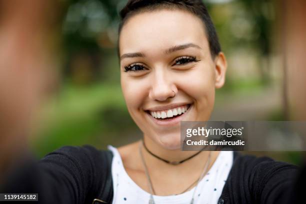 happy young woman taking selfie outdoors - beautiful college girls stock pictures, royalty-free photos & images