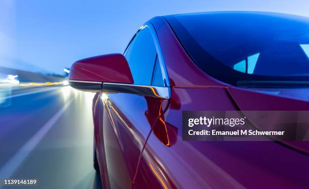 electric powered driverless car drives on highway while dawn - driverless cars fotografías e imágenes de stock