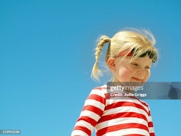 portrait of a child with blue sky behind - red white and blue beach stock pictures, royalty-free photos & images