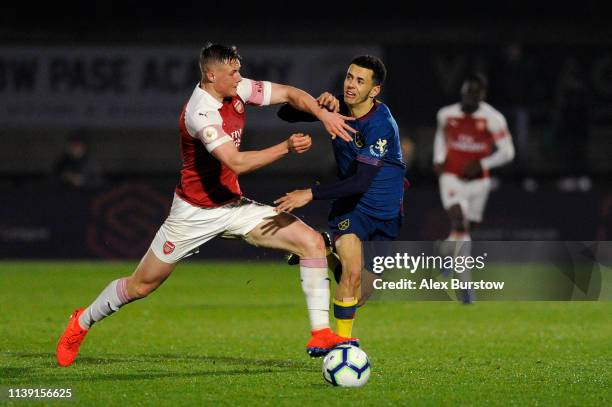 Danny Ballard of Arsenal tackles Nathan Holland of West Ham United during the Premier League 2 match between Arsenal U23 and West Ham United U23 at...