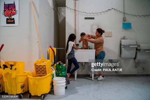 Woman bathes her son in a sink at the Casa del Refugiado, or The House of Refugee, a new centre opened by the Annunciation House to help the large...