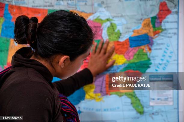 Guatemalan woman touches a map of the United States at the Casa del Refugiado, or The House of Refugee, a new centre opened by the Annunciation House...