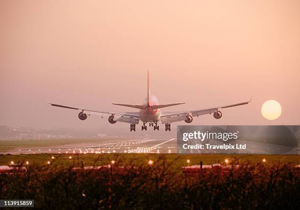 boeing 747 landing into sunset - landing foto e immagini stock