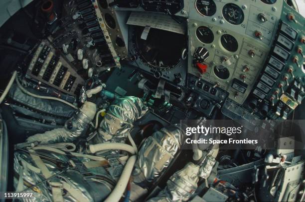 American astronaut John Glenn at the controls of the Friendship 7 capsule in which he orbited the Earth on NASA's Mercury-Atlas 6 mission in 1962....