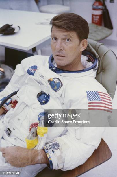 Apollo 7 Astronaut Walter Schirra has his spacesuit adjusted before entering the spacecraft for simulated altitude runs in the altitude chamber at...