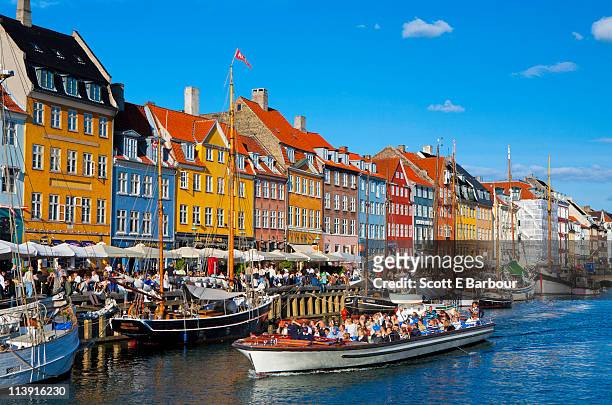 nyhavn canal. boatspeople on harbour - copenhagen stock pictures, royalty-free photos & images