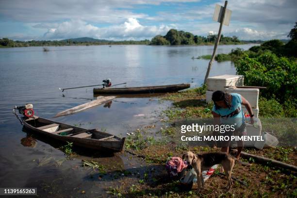 An Arara indigenous woman people arrives to her home located on the riverbank of the Iriri river at the Laranjal tribal camp, in Arara indigenous...