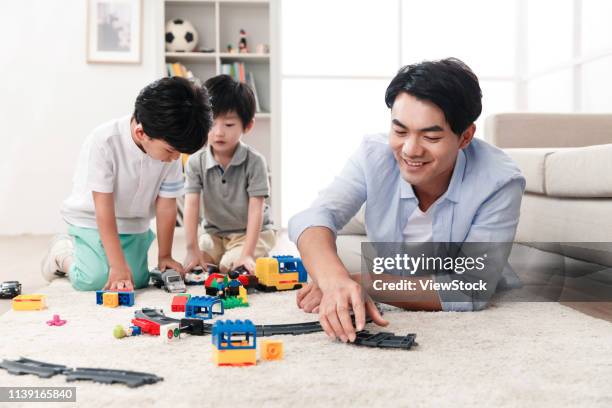 happy father and son play in the living room - east asian ethnicity fotografías e imágenes de stock