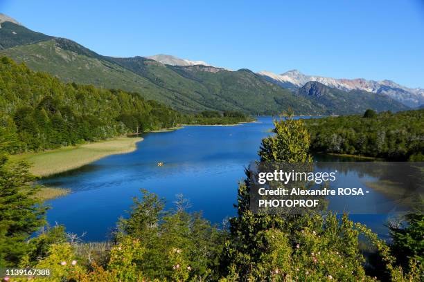 yellow canoe on the blue waters of mascardi lake south of san carlos de bariloche in patagonia, argentina - bariloche argentina stock pictures, royalty-free photos & images