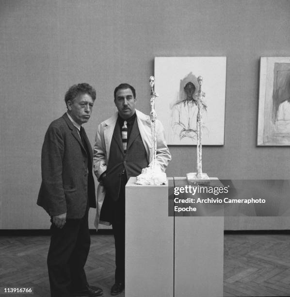 Swiss sculptor Alberto Giametti with the painter Giuseppe Santomaso next to Giacometti's sculptures at 31st Art Biennale in Venice, 1962.