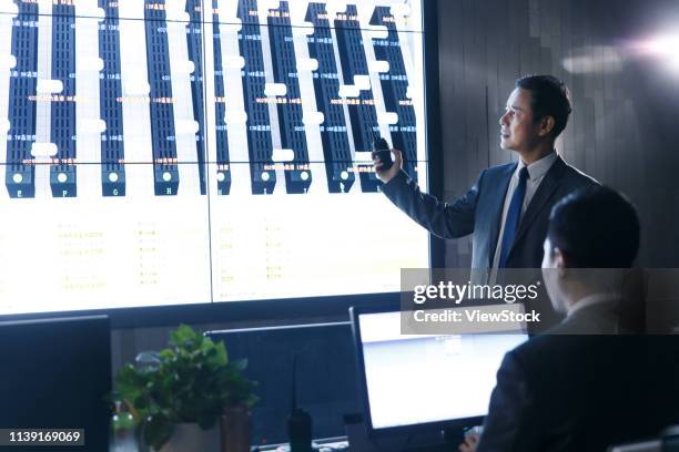 business people in the control room - mainframe stock pictures, royalty-free photos & images