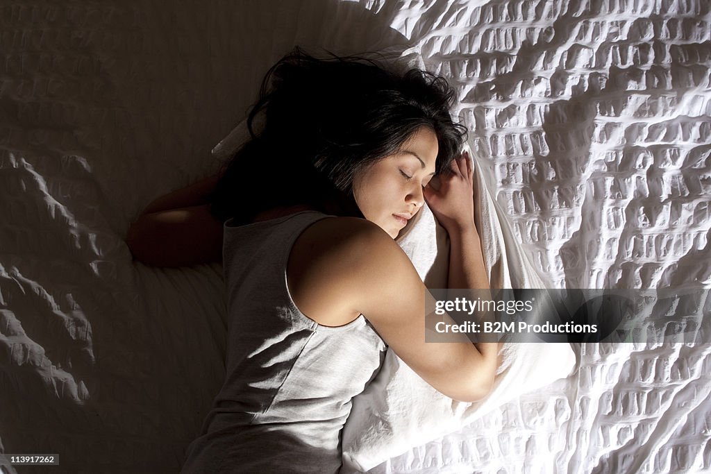 Woman sleeping on bed