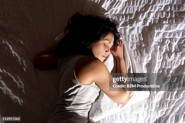 woman sleeping on bed - sleep ストックフォトと画像