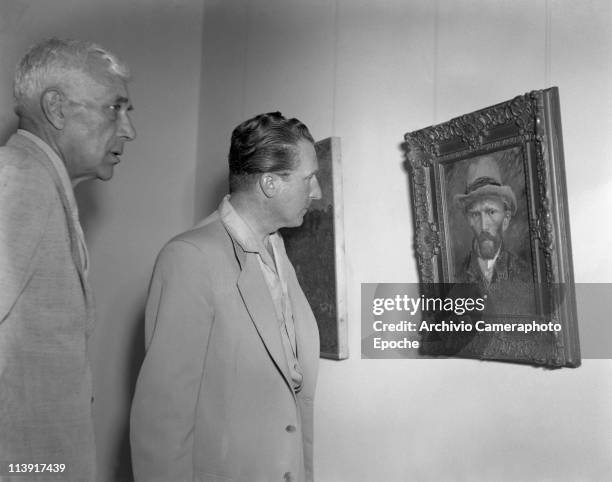 French painter Georges Braque with the art dealer Aime Maeght watching Van Gogh self-portrait at the Art Biennale in Venice, 1948.