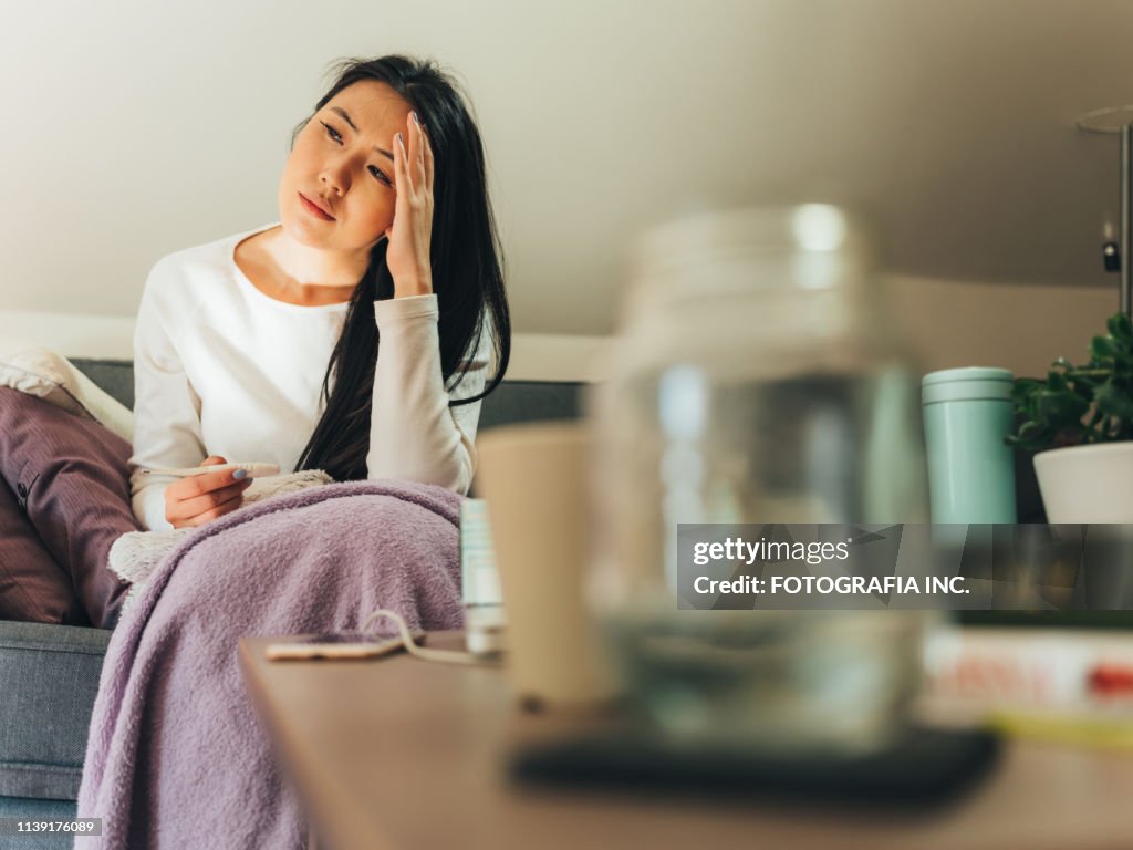 Young Asian woman sick at home